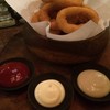Onion rings with ketchup, mayonnaise and wasabi sauce 