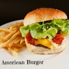 Homemade cheese burger with bacon, fresh lettuce, tomato and onion served with f