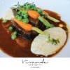 Braised beef cheeks in red wine sauce with mashed potato and young vegetables