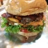Monster-size double-decker bacon cheeseburger with caramelized onions