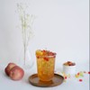 Peach tea with rainbow bubble by glass