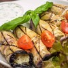 Eggplant rolls with cheese, garlic, walnuts, herbs and tzatziki sauce