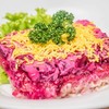Layered salted herring salad with layers of grated boiled beetroot, carrot, onio