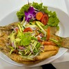 Deep fried fish topped with green mango salad 