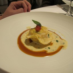 Ravioli of lobster, langoustine and salmon poached in a light bisque with a cher