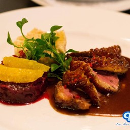 เนื้ออกเป็ดซอสส้มเสิร์ฟกับกะหล่ำแดงและมันฝรั่งอบชีส เนื้อเป็ดจะย่างแบบหนังกรอบ