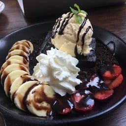Hot Brownie With Slices Of Banana And Strawberry And Scoop Of Vanilla Ice Cream