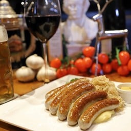 Bavarian Nuremberg sausage on Sauerkraut and Dark Beer Jus