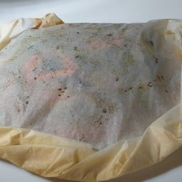 Baked seabass in foil with vegetable, olive oil, garlic and lemon drop