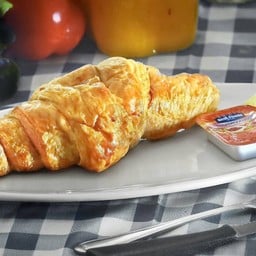 Croissant served with jam and butter