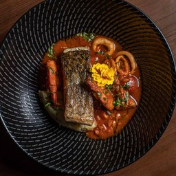 Filetto di Branzino con Zuppetta di Mare, Farro, Schiacciata di Patate