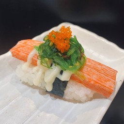 Sushi with crab stick topped with salad + seaweed salad with orange fish roe