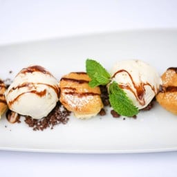 Profiteroles with Vanilla Ice Cream, Crumble and Chocolate Sauce