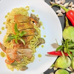 Homemade pasta with green curry sauce and grilled chicken