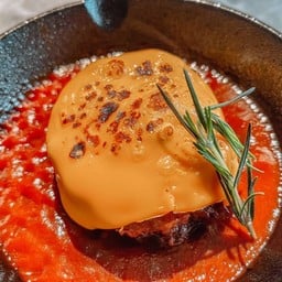 Black Angus Hamburger steak on cheese with tomato sauce