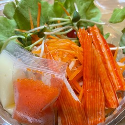 Vegetable salad with crab sticks and ebiko