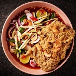 Spicy salad with green mango, cashew nuts and crispy catfish