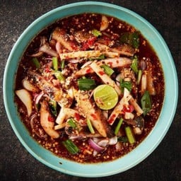 Spicy salad with grilled pork neck, lotus stem and roasted rice powder