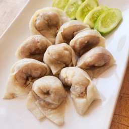 Dumplings with fish served with dipping sauce