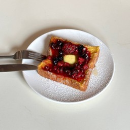 French toasted with mixed berries and meple syrup