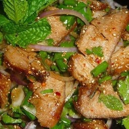 Grilled pork salad with spicy dipping sauce and fresh herbs