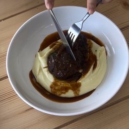 Slow cooked beef cheek in red wine sauce with creamy mashed potatoes