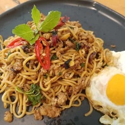 Homemade pasta with minced pork, hot basil and fried egg.