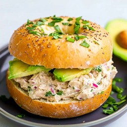 Avocado tuna salad bagel sandwich