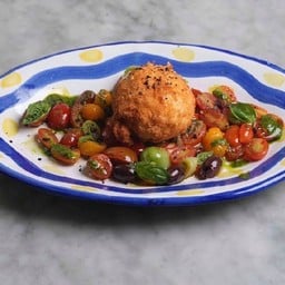 A whole fresh Burrata from Andria, deep fried Crispy on the outside, soft & creamy on the inside Served with Chiang Mai organic cherry tomatoes Black olives, ca