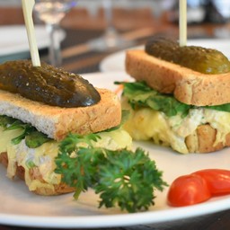 Tuna salad sandwich with avocado, spinach mozzarella cheese on whole wheat toast