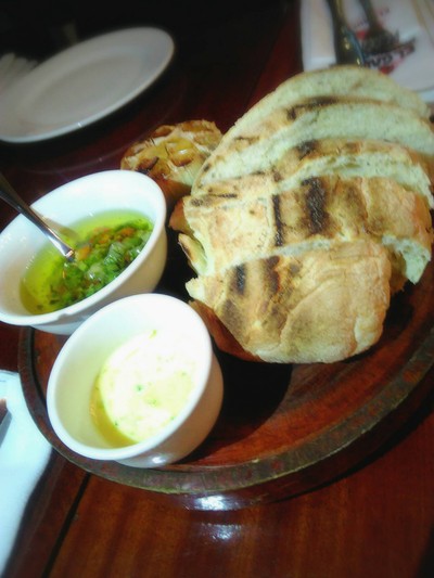 Bread served with Salsa Criolla and Garlic butter  .