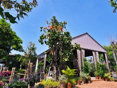 ร่มรื่มไปด้วยต้นไม้ สวนดอกไม้ รายล้อมตัวอาคารคาเฟ่