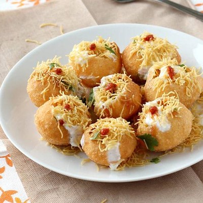 Round hollow crispy puri fried
filled with stuffings & filled with of water