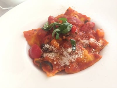 Ravioli filled by red snapper and herb with cherry tomato sauce and olives