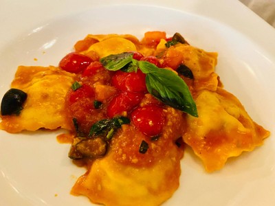 Handmade Ravioli Pasta Filled with Red Snapper and Herbs with Cherry Tomato Sauce and Olives