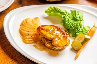 Panfried french foiegars with apple and onion confit flamed with honey and brandy.