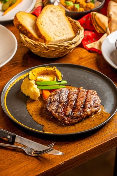 Ribeye truffle butter sauce served with roast potatoes in duck fat.